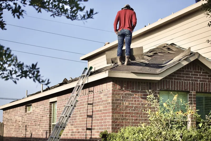 Professional roofer working on a residential roof in Lewis Mill